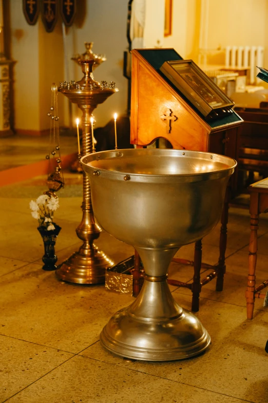 a pew with the remains of a burning candle inside it