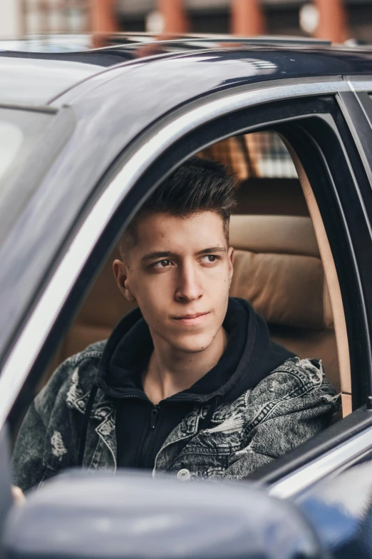 a man sitting inside a car looking out of the window