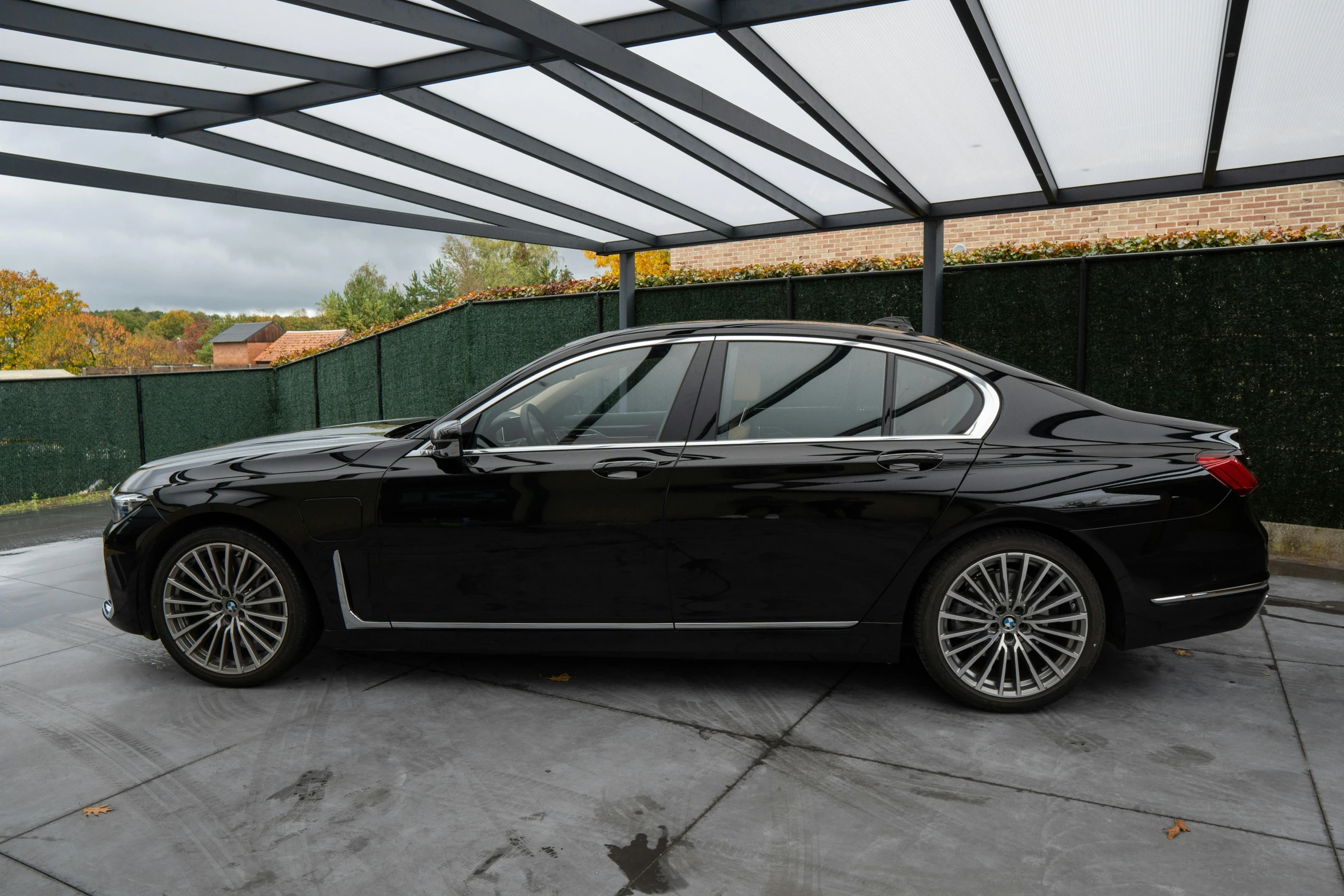 a black car parked under an open roof