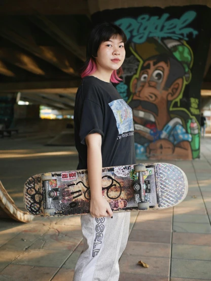 a girl with pink hair stands on the sidewalk holding her skateboard