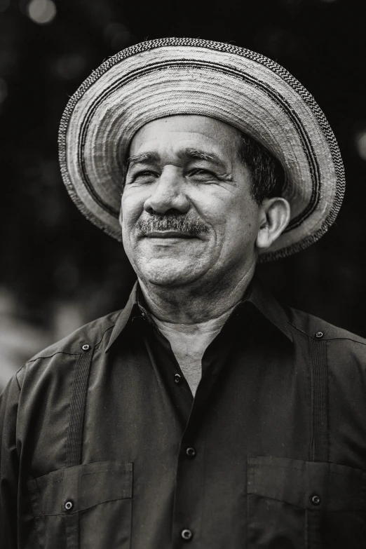 an older man wearing a straw hat and smiling