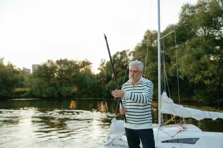 a man with a white beard fishing on a boat