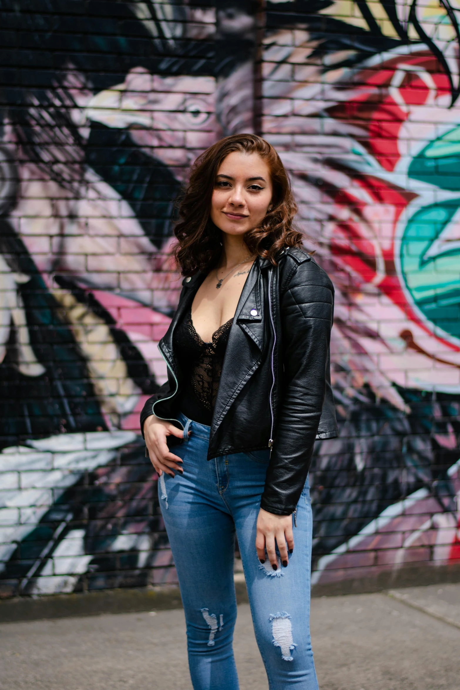 a beautiful woman in jeans posing for the camera