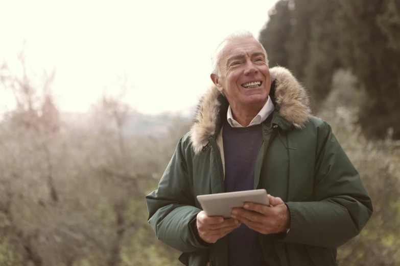 a man standing outside using his ipad