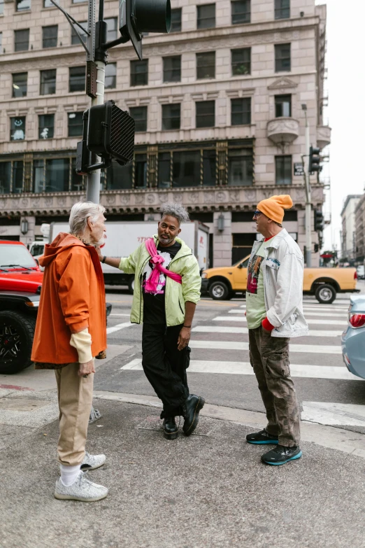 three men standing near a street light on the side of a road