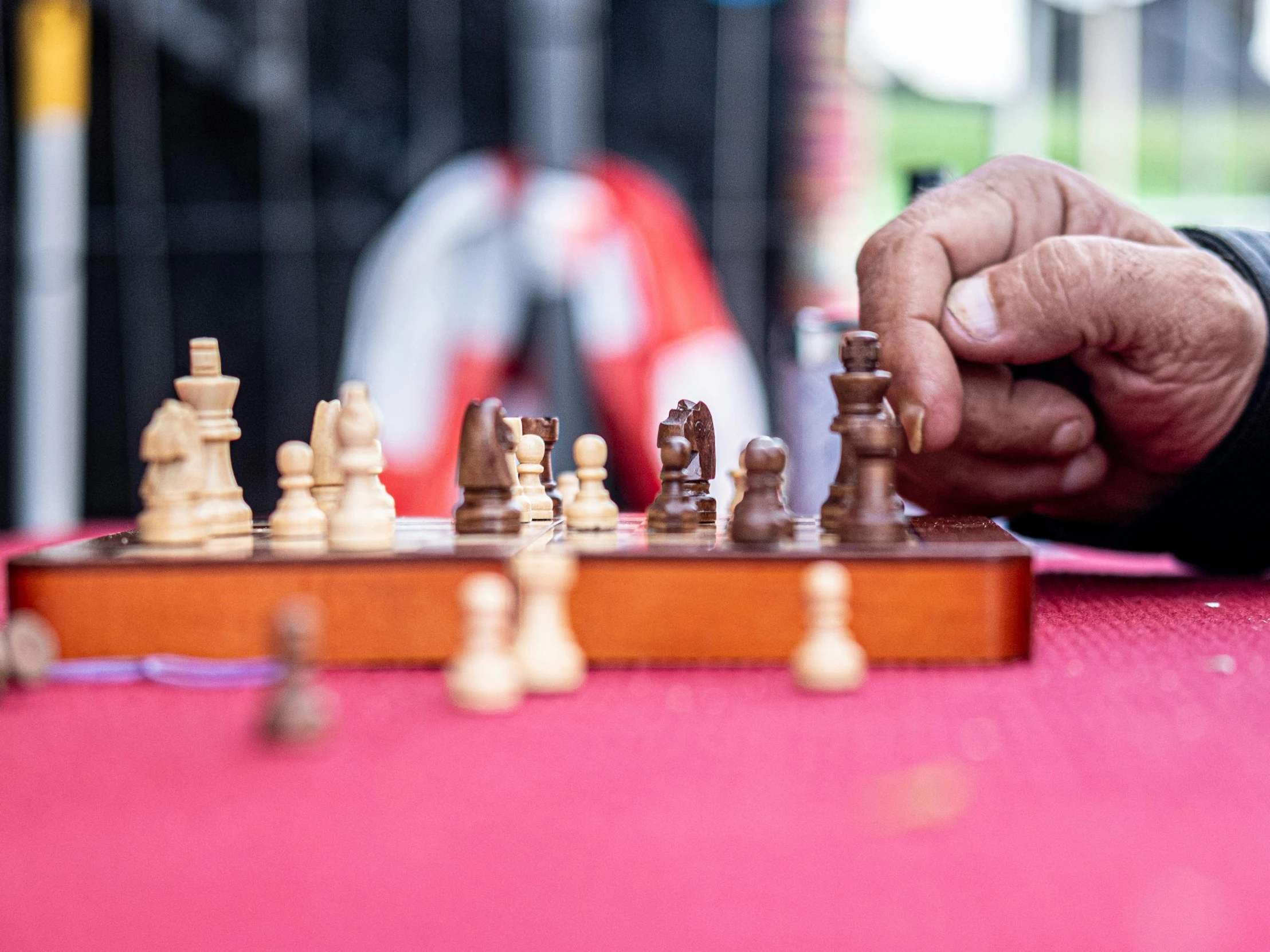 a man with his hand on a chessboard