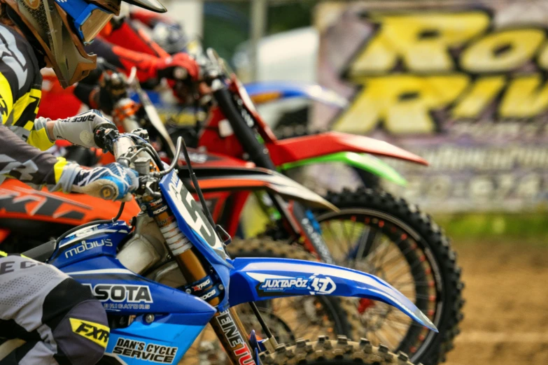 some dirt bike riders lined up for their next race