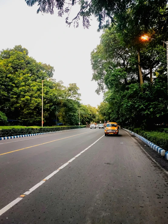 a couple of cars are parked at the side of a street