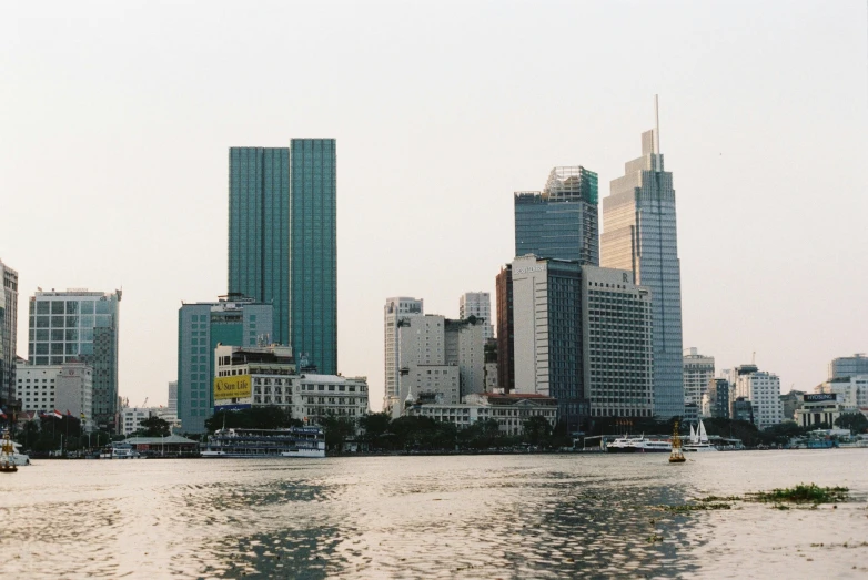 a river with buildings on both sides and tall buildings at the side