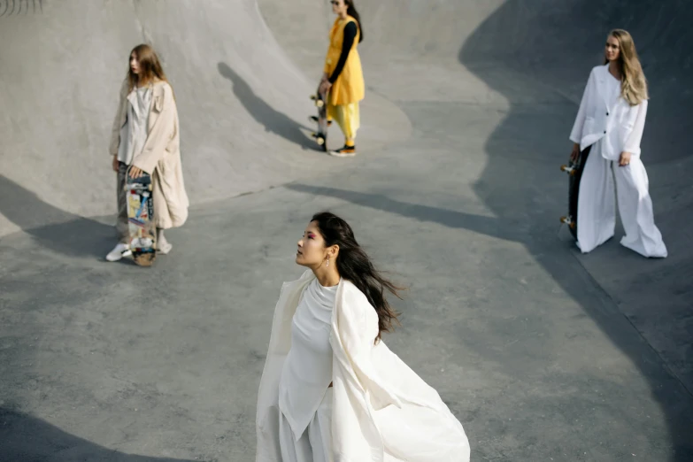 a woman in a white dress standing near a ramp