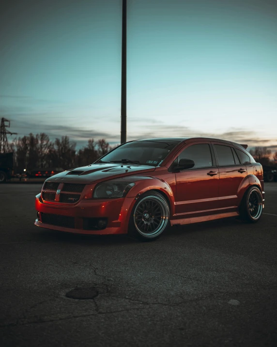 red car with matching tires parked in parking lot