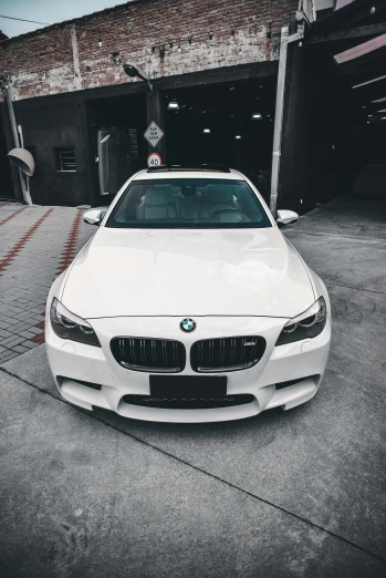 a white bmw car parked in a parking space