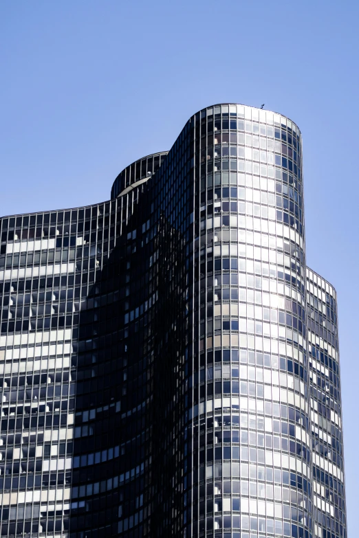 an airplane flying in the air behind a building