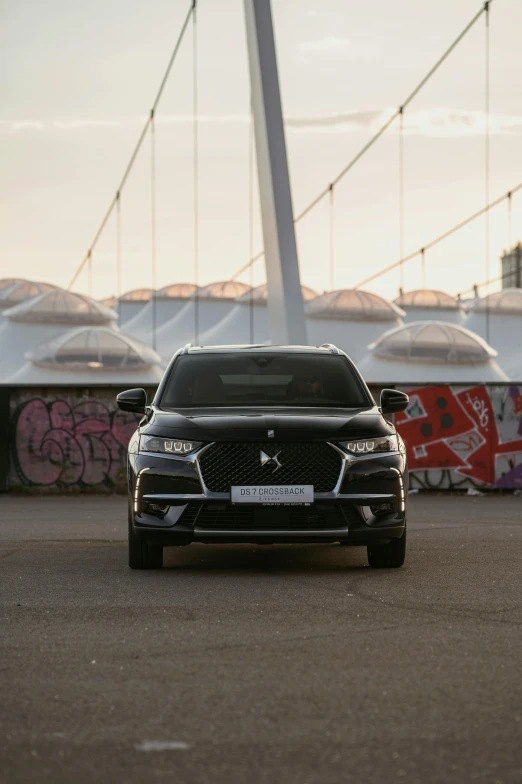 a vehicle parked outside in front of a bridge