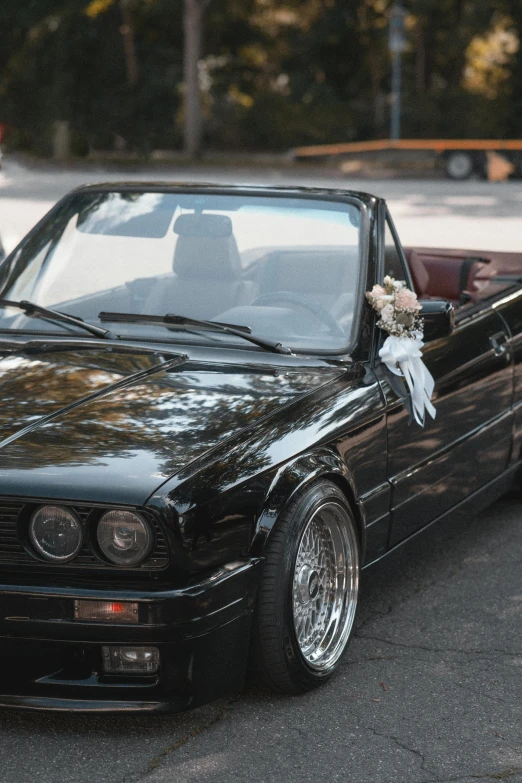 a black bmw e34 parked on the street