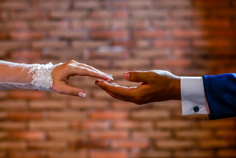 the bride and groom are holding each other's hand