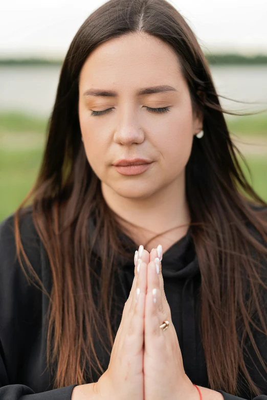 a woman in a black jacket meditating