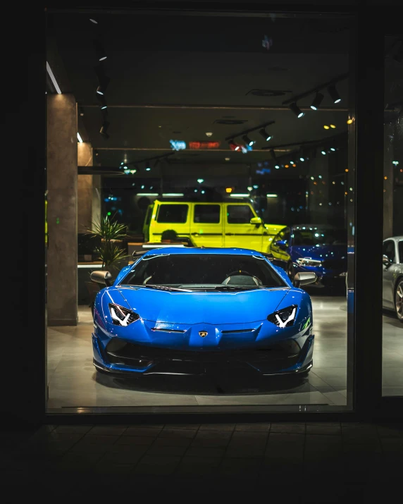 two bright colored cars are shown through a window