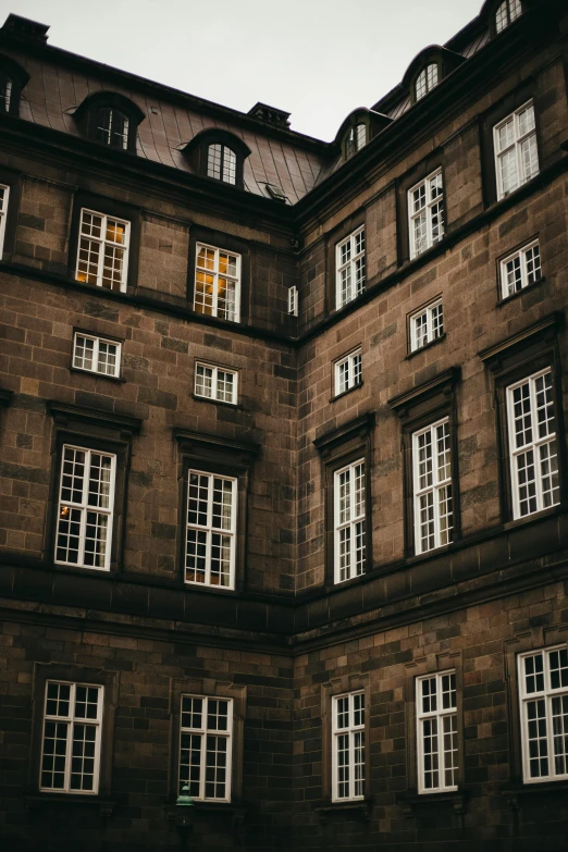 an old building with white windows and a clock on the front