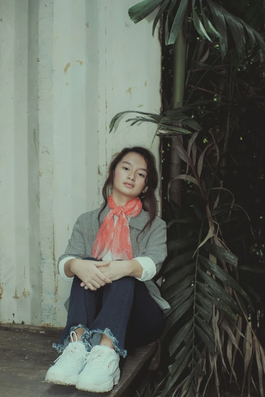 the young woman is wearing a bright red scarf