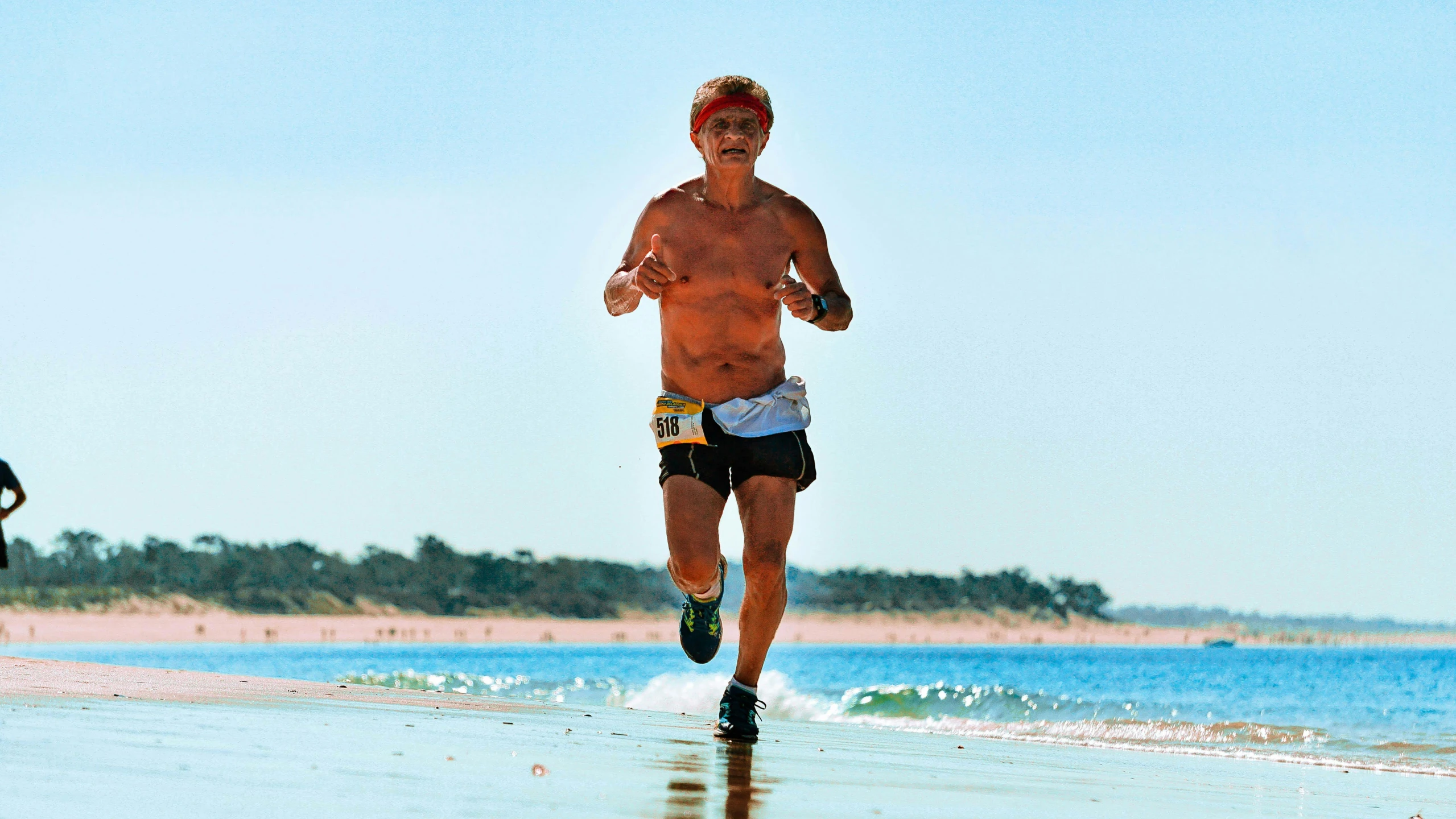 a man that is running on a beach