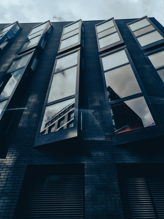 the bottom part of a tall building, showing some windows