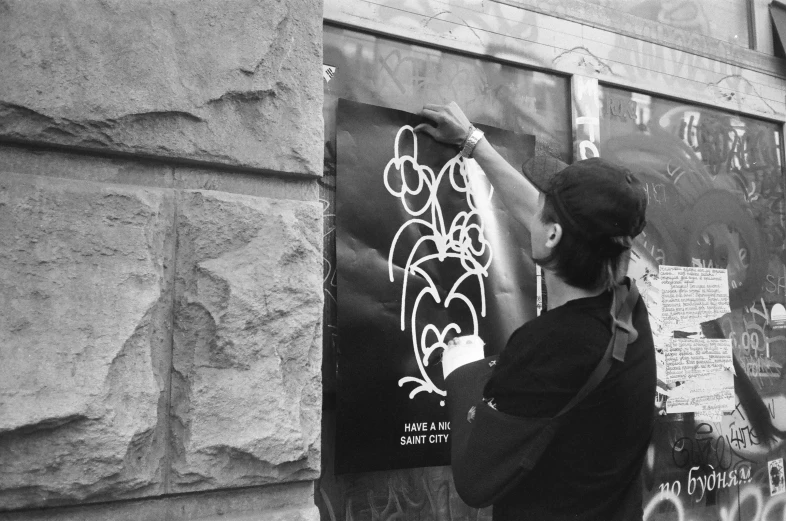 a person writing on a building wall