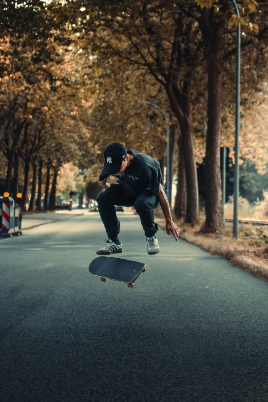 the man jumps in the air on his skateboard