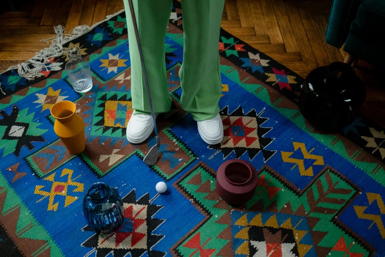 a person stands on the carpet with a colorful rug