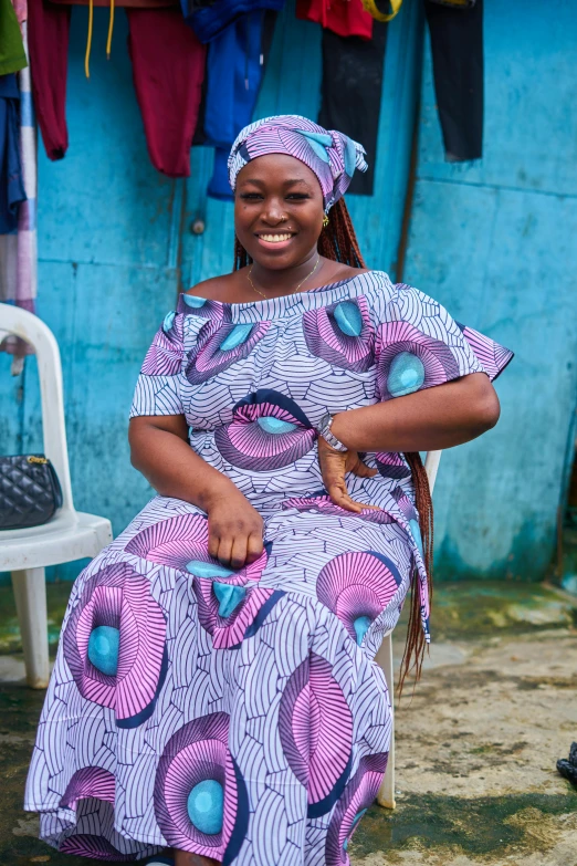 a woman is sitting on a chair outside