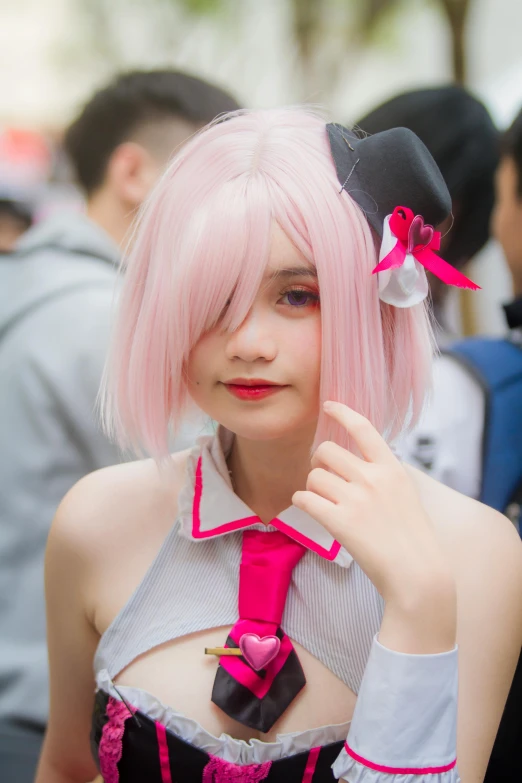 a woman in pink hair and a top with bow ties on her head