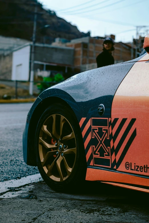 the side of a car with an orange and black stripe on it