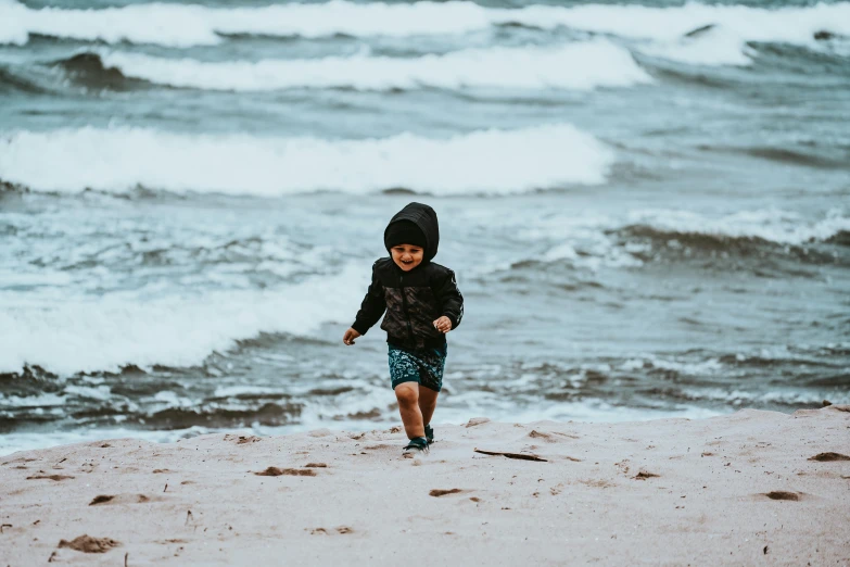 a  is running along the beach with waves