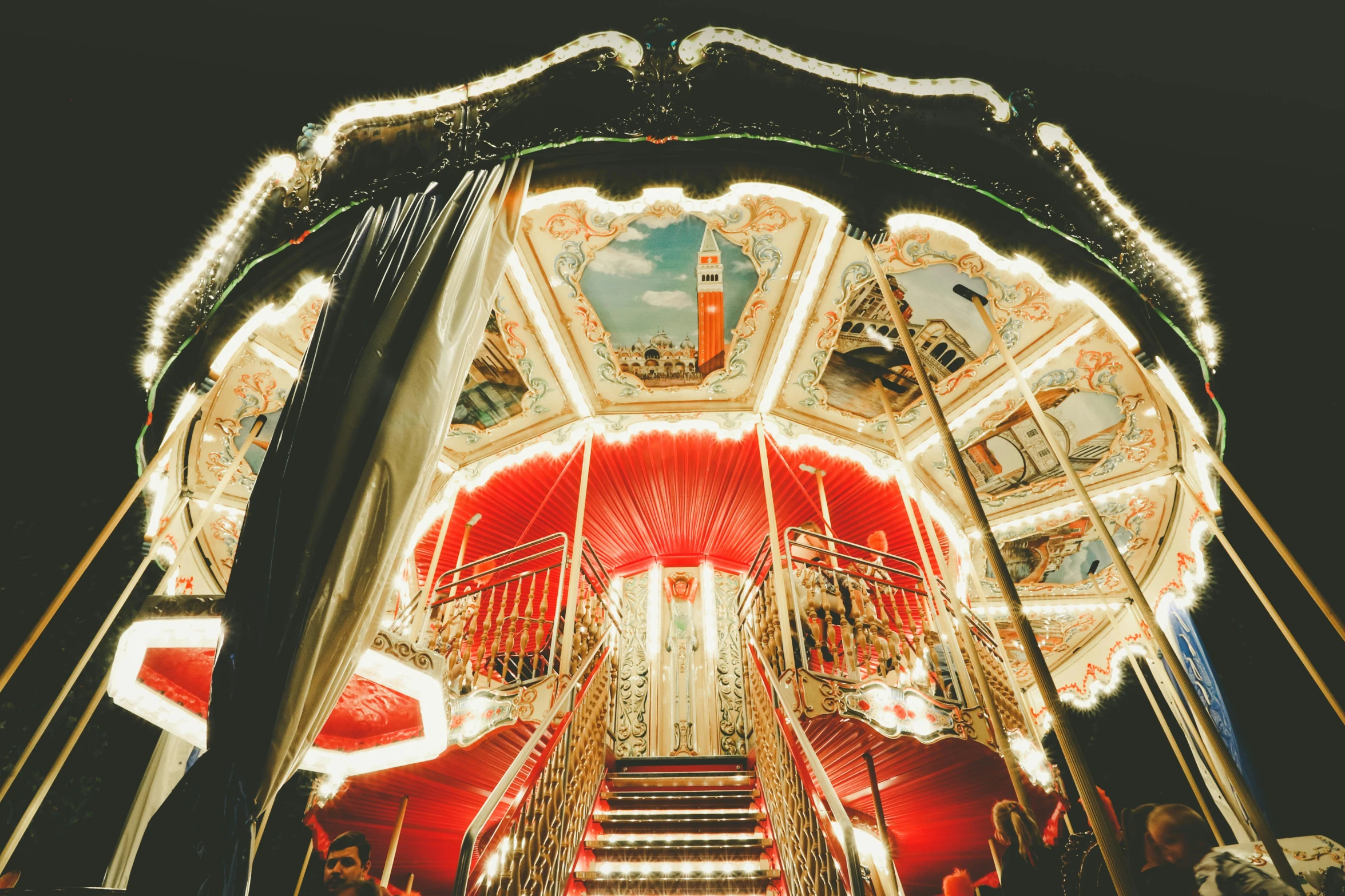 an elaborate carnival rides is lit up with lights and decorations