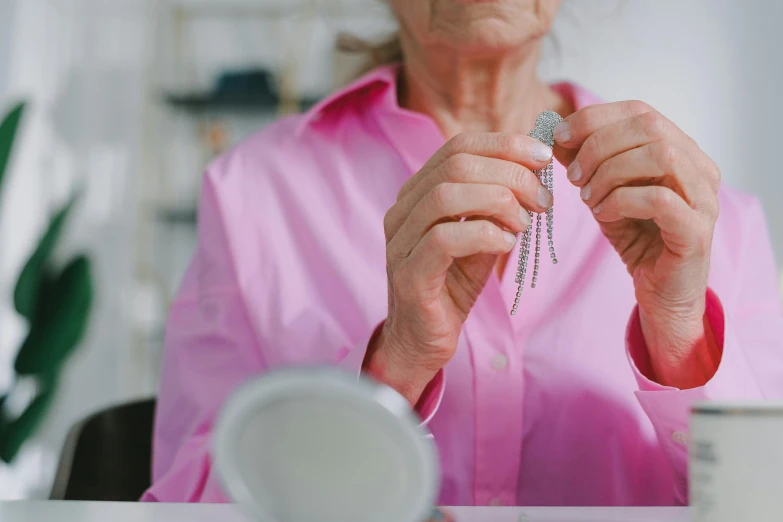 a woman is putting on a diamond ring