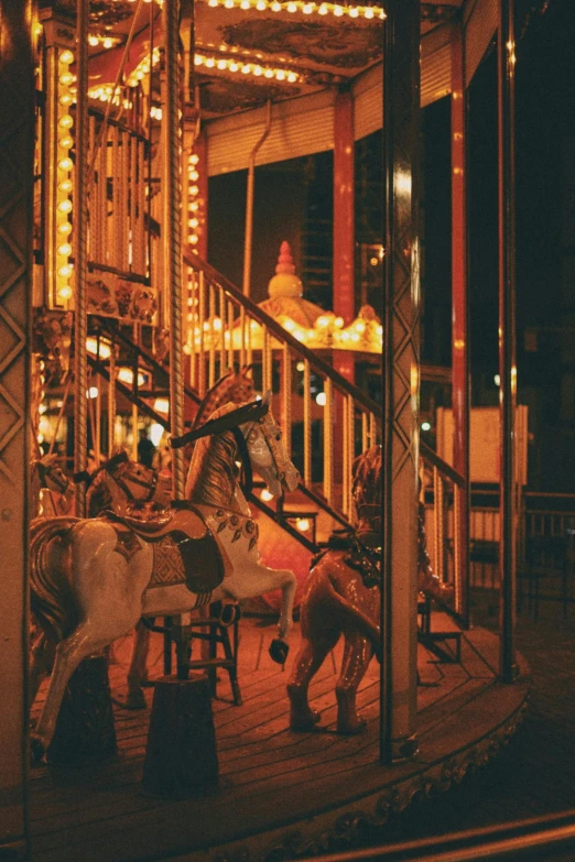 a carousel ride lit up and riding horses