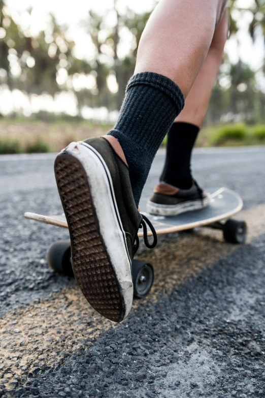 a man is riding his skateboard down the road