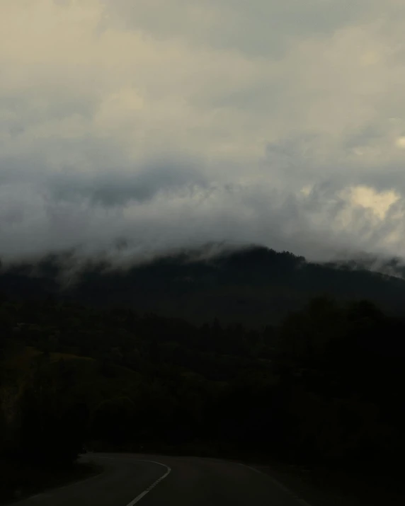 the clouds roll in over the mountains and trees