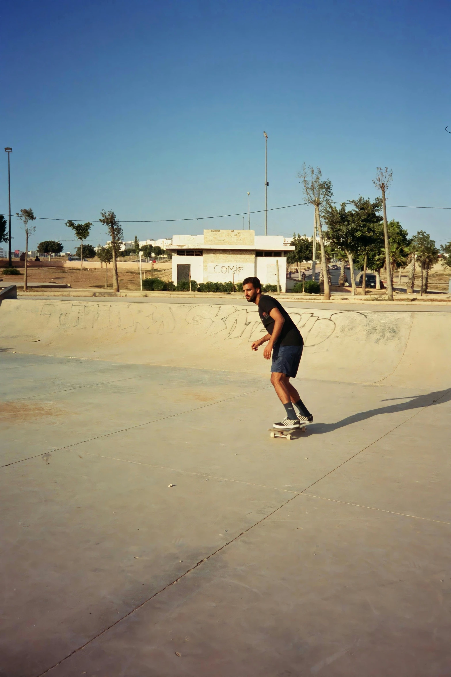 a man riding a skateboard around a pool