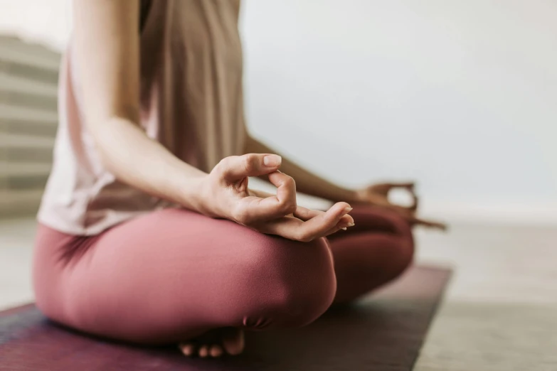 the woman is meditating in the yoga class