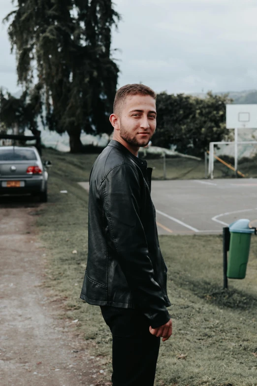 a man is standing in front of the parking lot