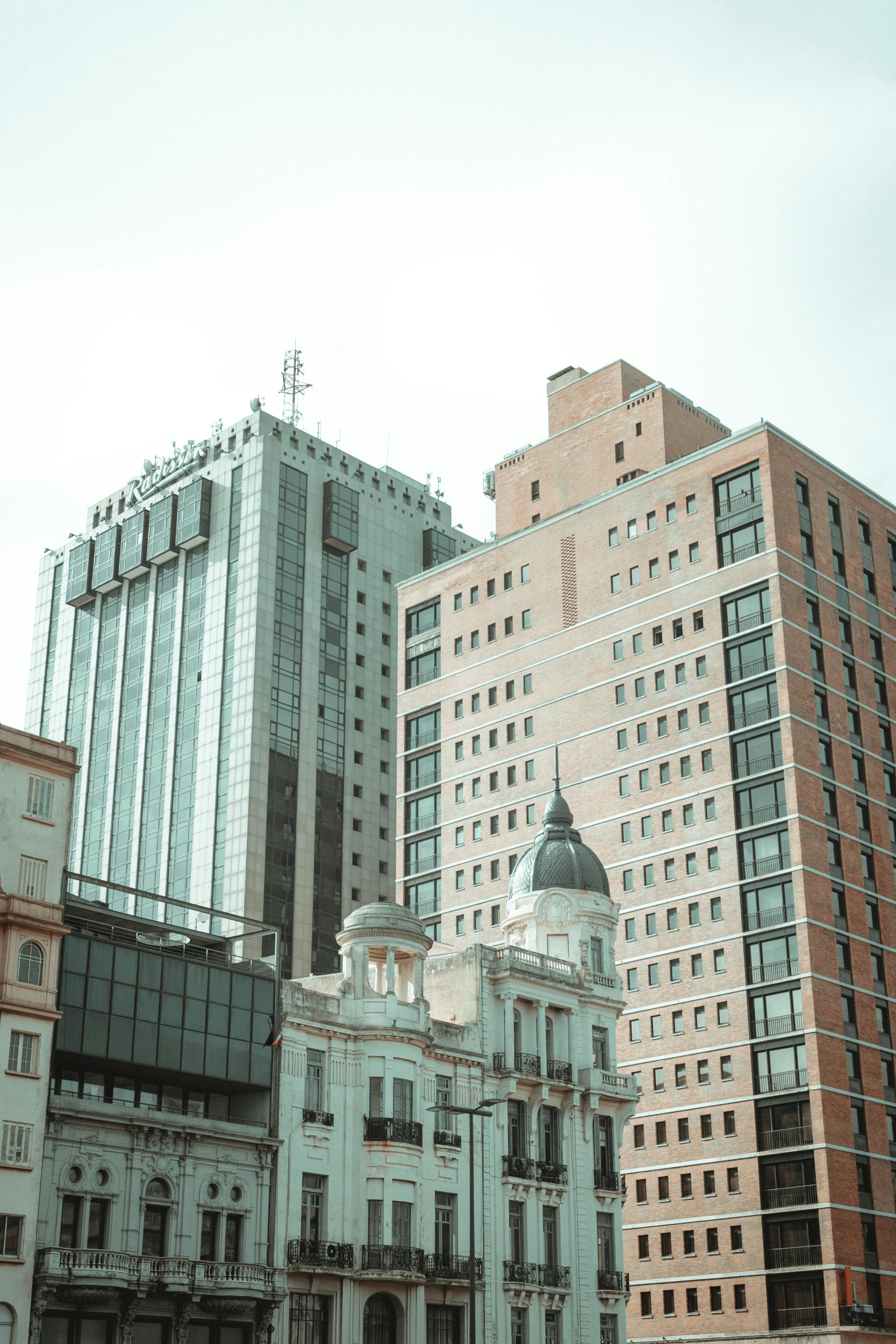 the buildings in the city are surrounded by many other tall buildings