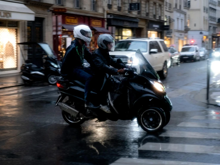 the two people are on the motor bike