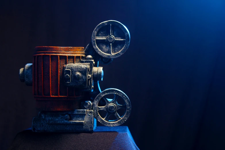 an old fashioned movie projector set on top of a table