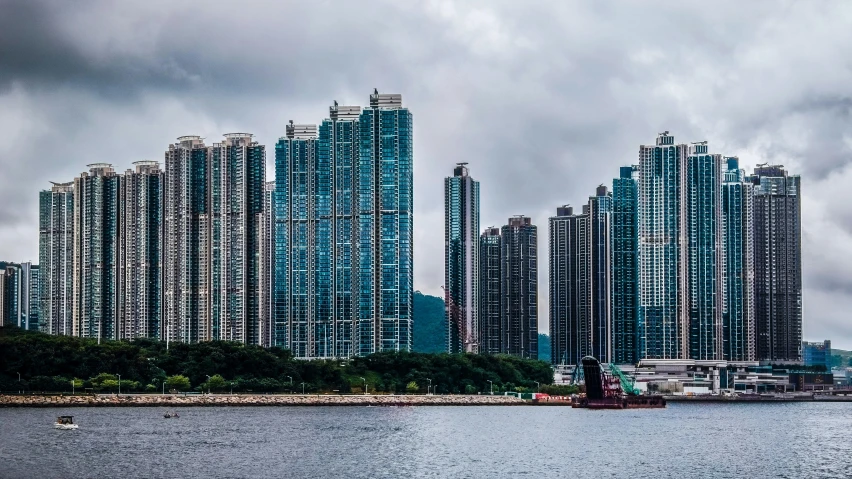 two boats on the water near tall buildings