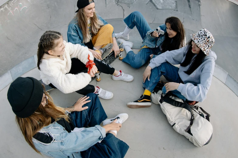 six s sitting in a circle on the skateboard ramp