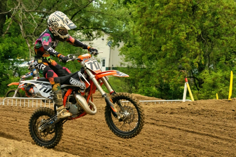 a dirt bike rider is going in the dirt