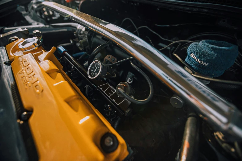 the engine compartment of an old yellow car