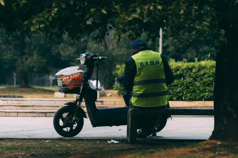 a man riding a scooter on the side of a street