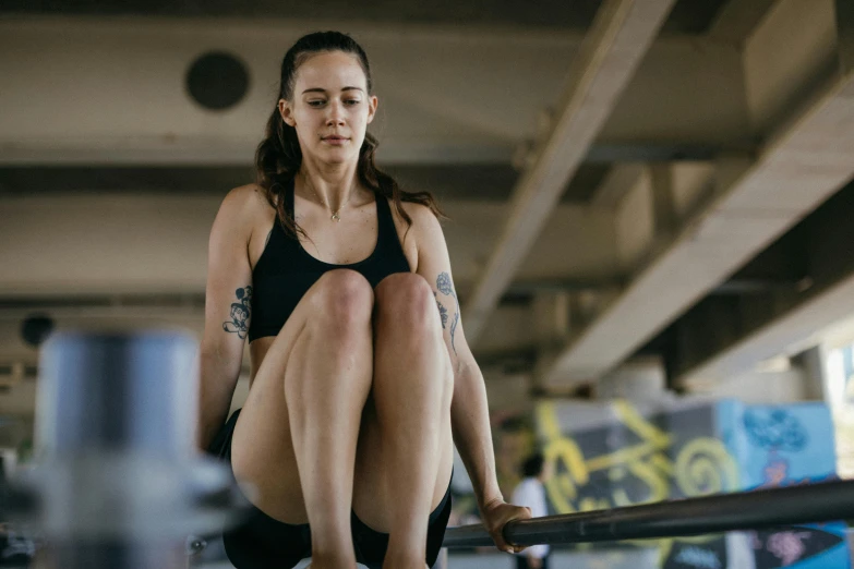 a woman riding on a rail with no shoes